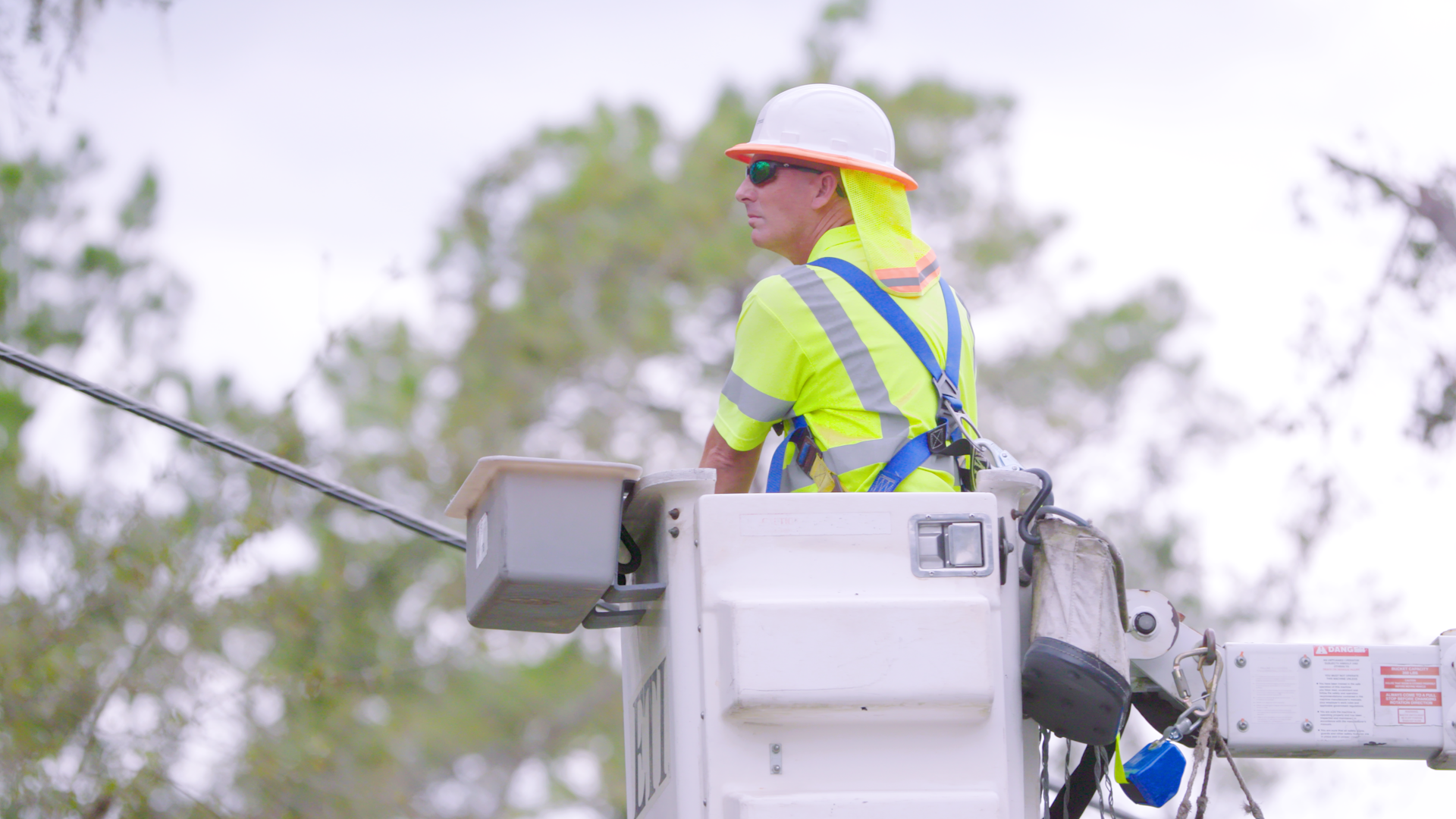 A Comcast tech in a bucket truck.