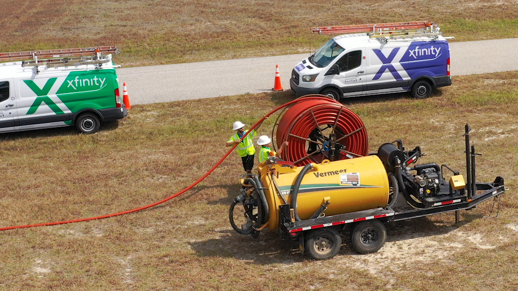 Comcast techs laying fiber cables.