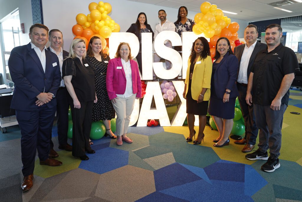 Comcast Employees pose for a picture at event.