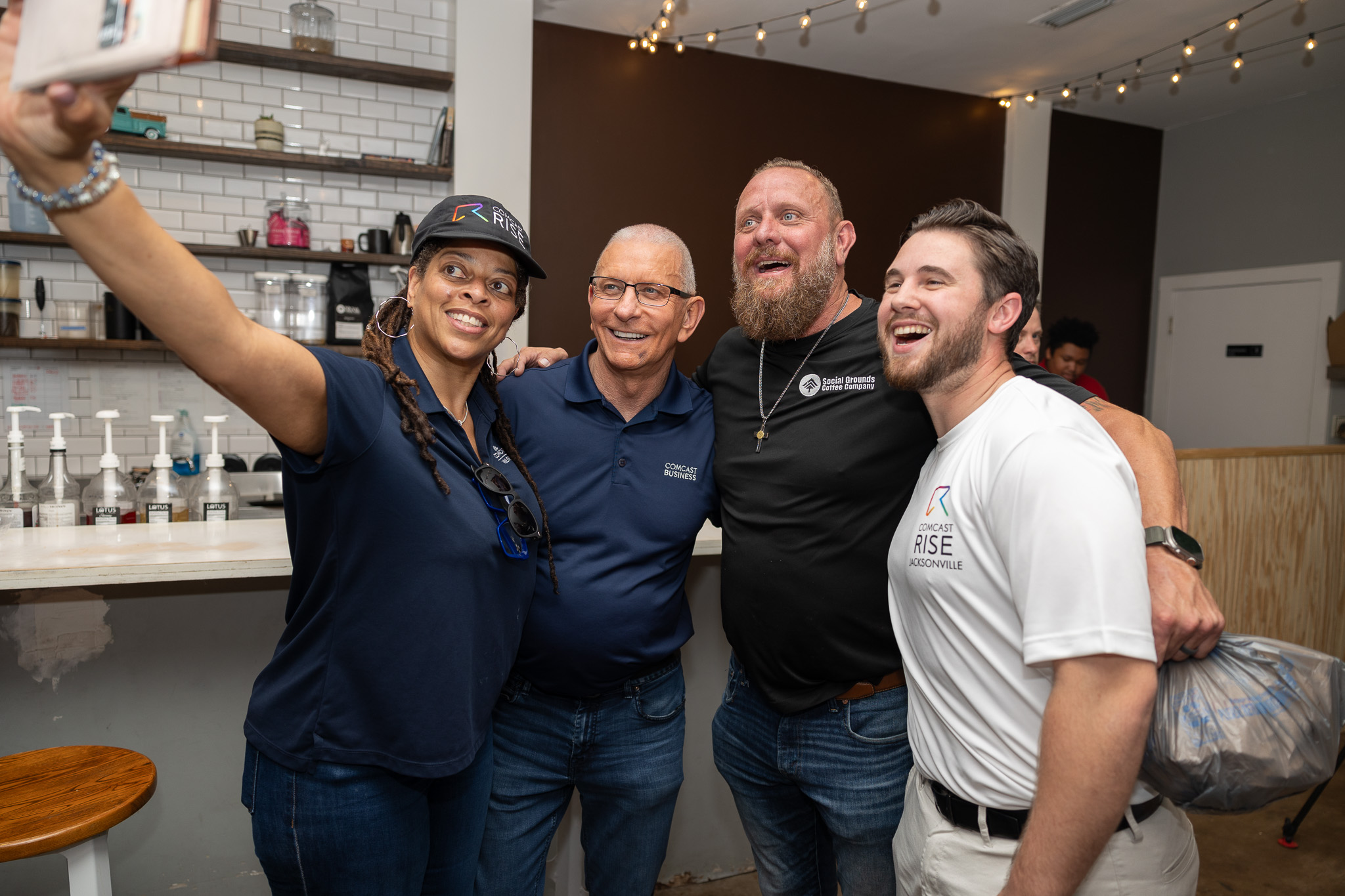 Comcast employees, Chef Robert Irvine, and Social Grounds Coffee Owner Jason Kelloway taking a selfie.