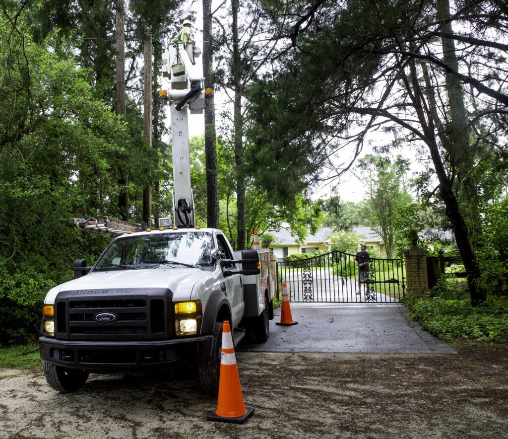 Xfinity tech works from a bucket truck outside a neighborhood in Tallahassee