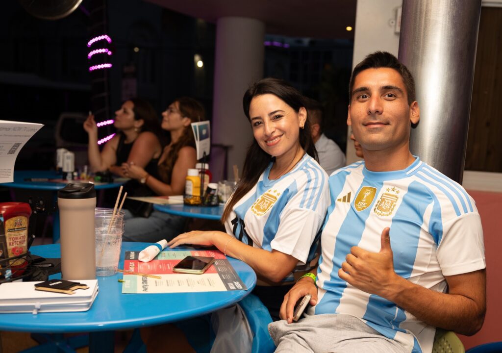 Two soccer fans pose for a picture