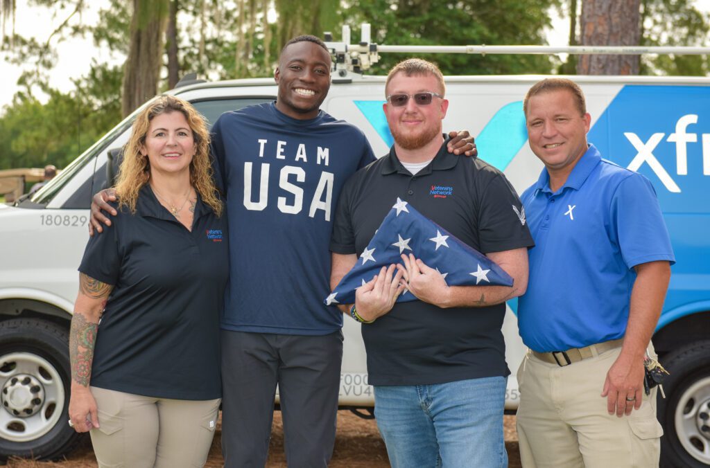 Grant Holloway participates in flag retirement ceremony.