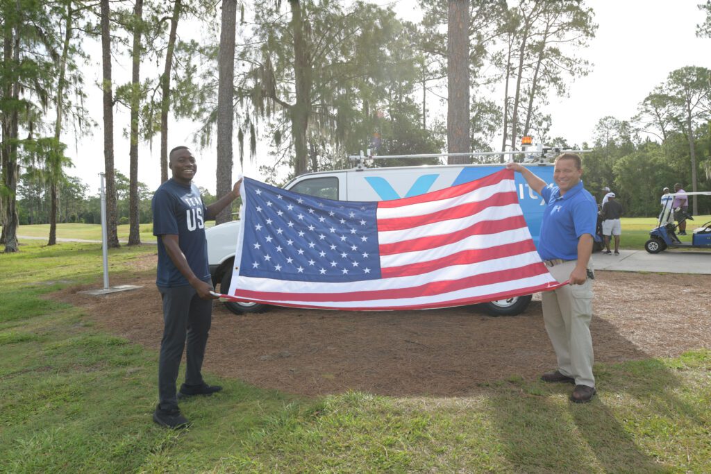 Grant Holloway participates in flag retirement ceremony.