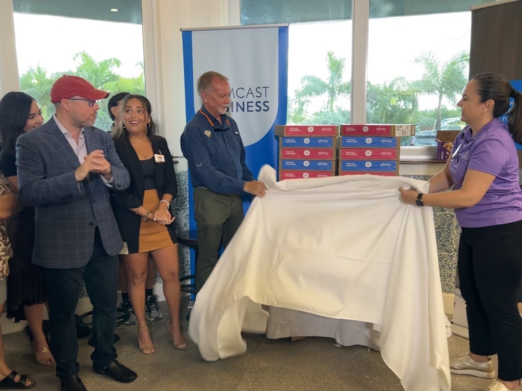 Sanibel Mayor Richard Johnson and Michelle McGovern, Comcast Florida VP of Government Affairs, unveil laptops for FISH of SANCAP.