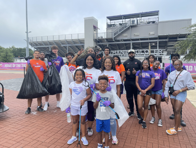 Group poses for photo after clean up event