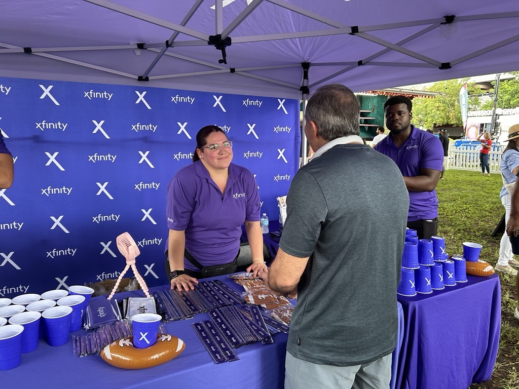 An Xfinity representative chats with a Coral Springs resident at Oktoberfest.