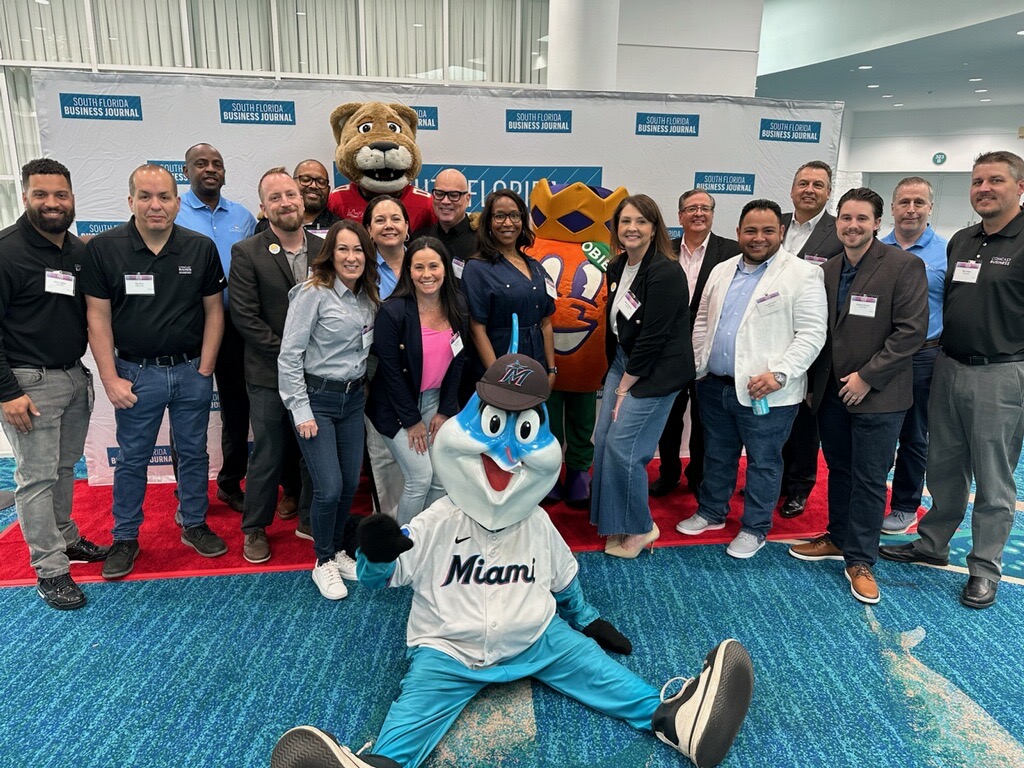 Comcast team poses with South Florida Sports Mascots