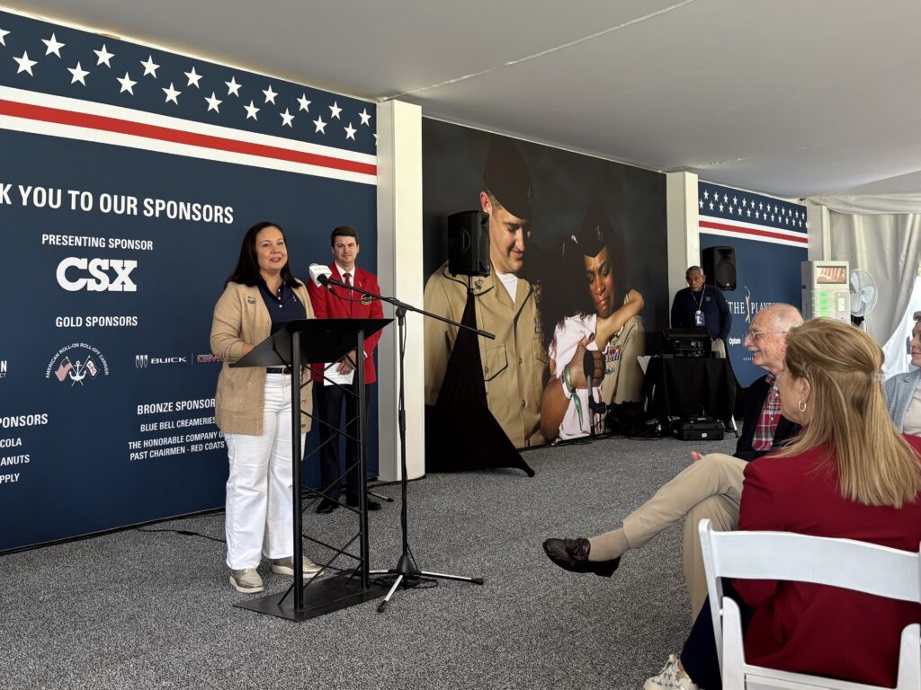 woman delivering remarks at an event
