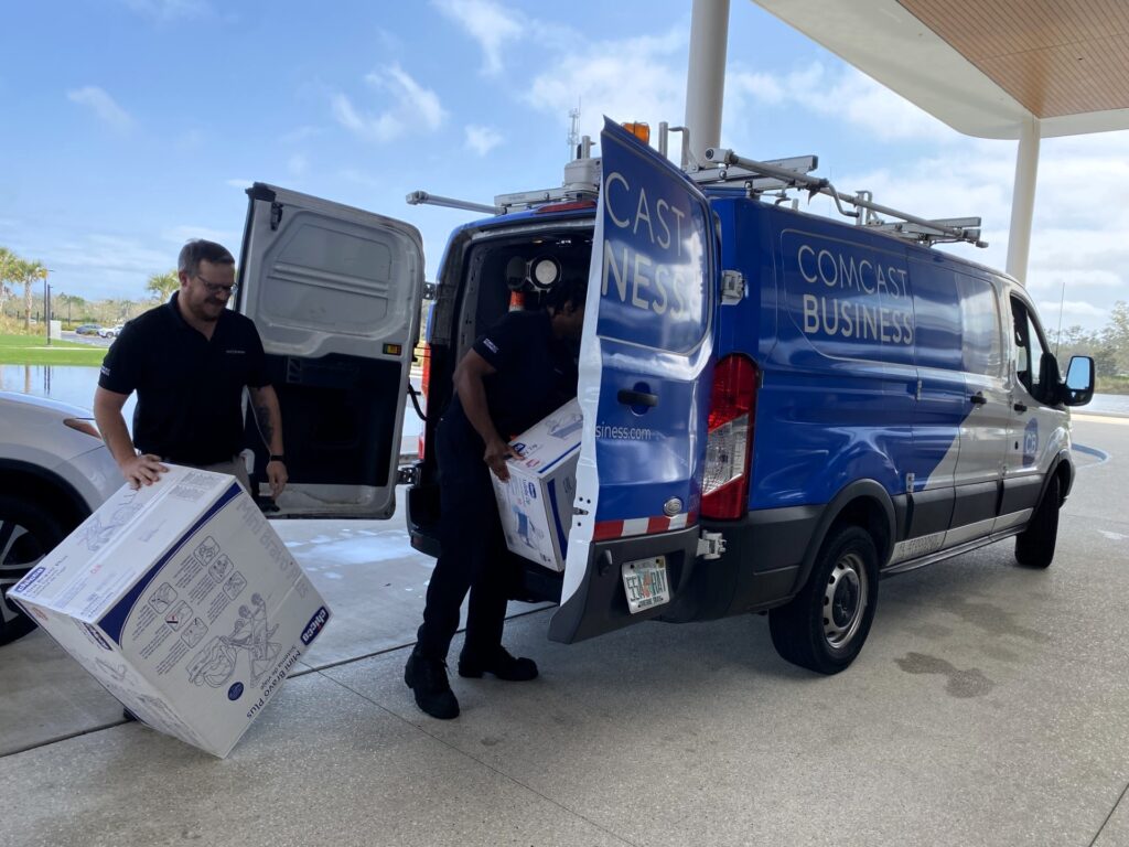 Comcast Business techs load the truck with overflow baby items.