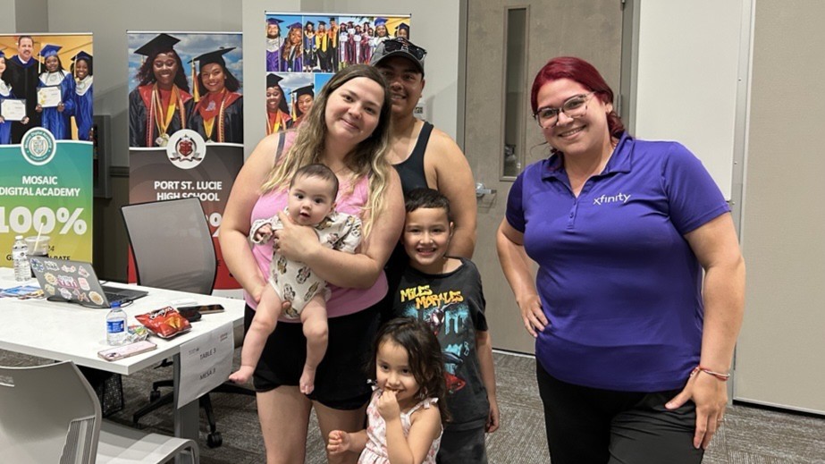 The Linares family pose with Comcast Rep Liz.