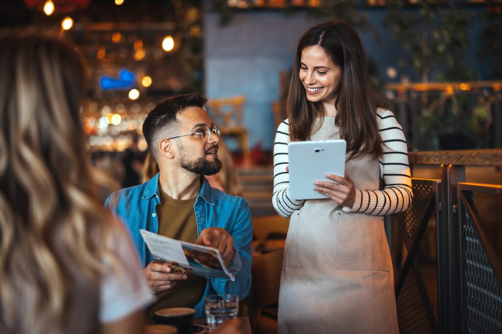Small businesses in Florida utilize Comcast Business to run their organization with fast, secure and reliable Internet and power their mobile devices. IMAGE: A local Florida shop with employees and customers on cell phones and tablets.