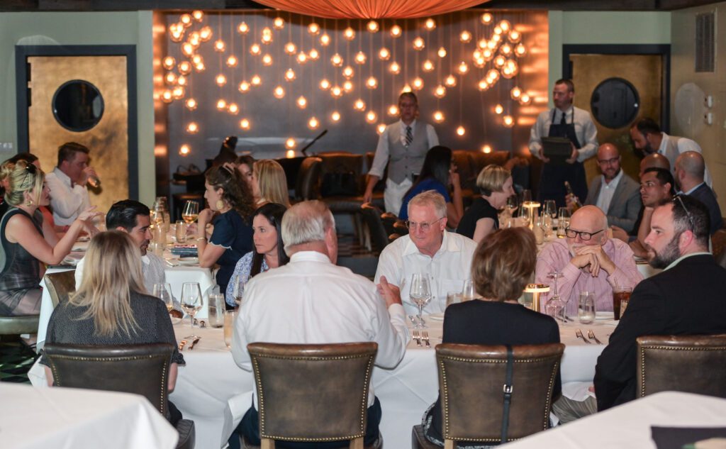 people at an event sitting in tables
