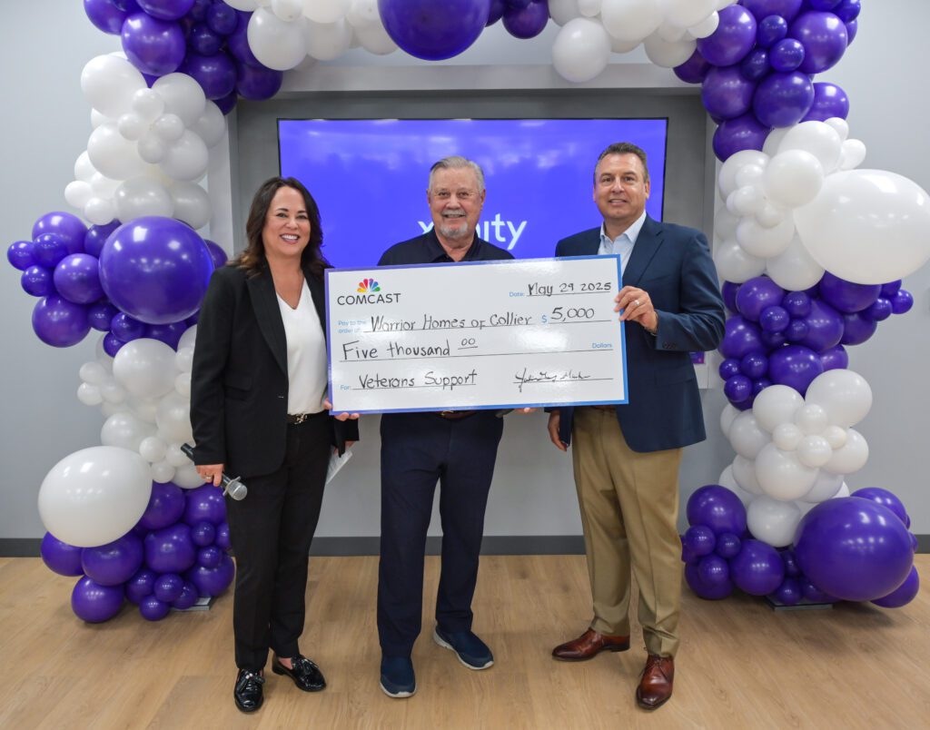 people holding a donation check