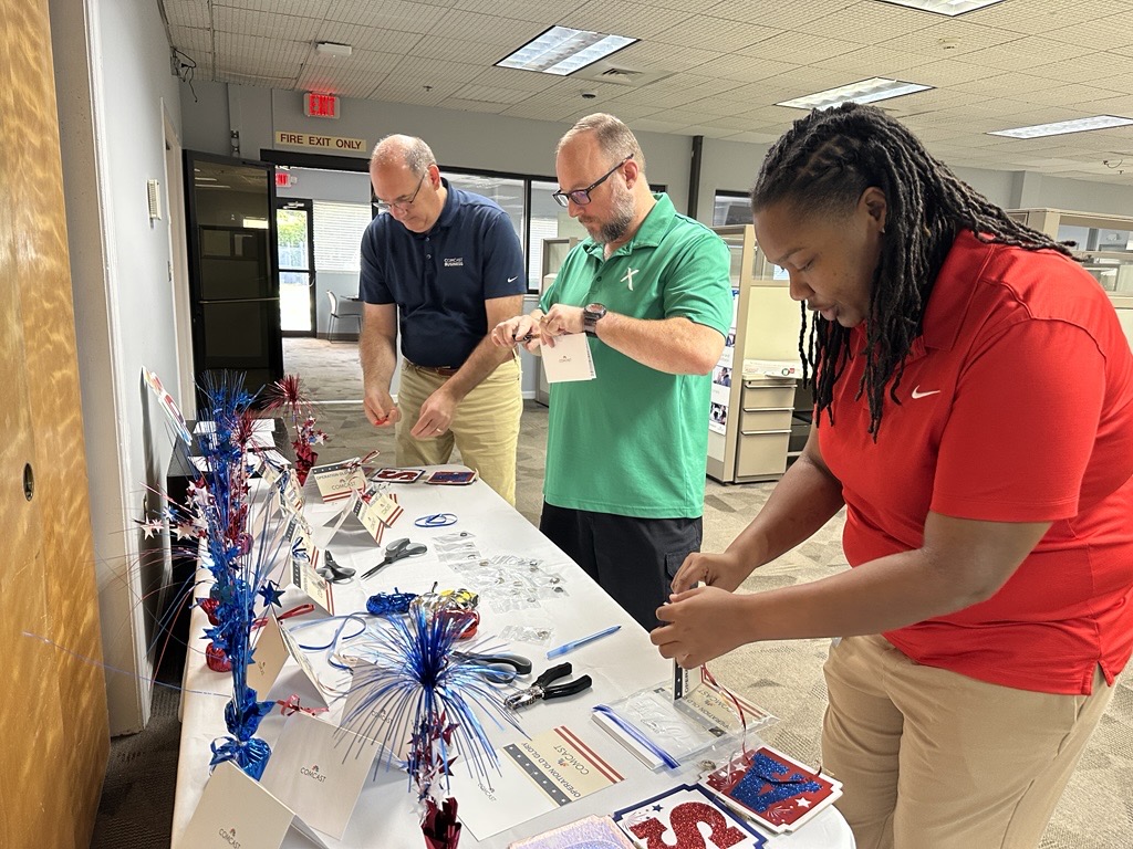people making keepsakes with grommets obtained from retired American flags.