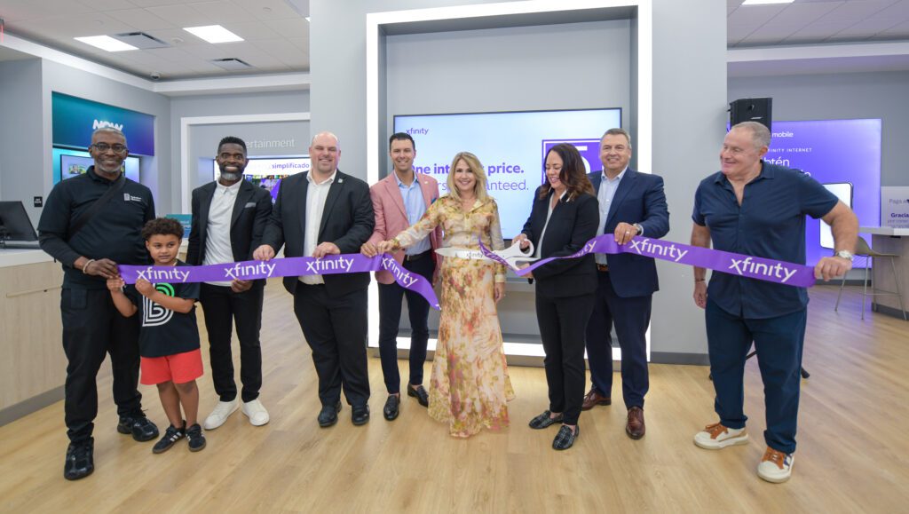 People cutting a ribbon at an event