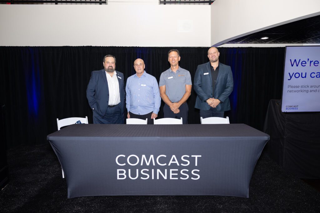 The four panelists smile for a photo at the event.