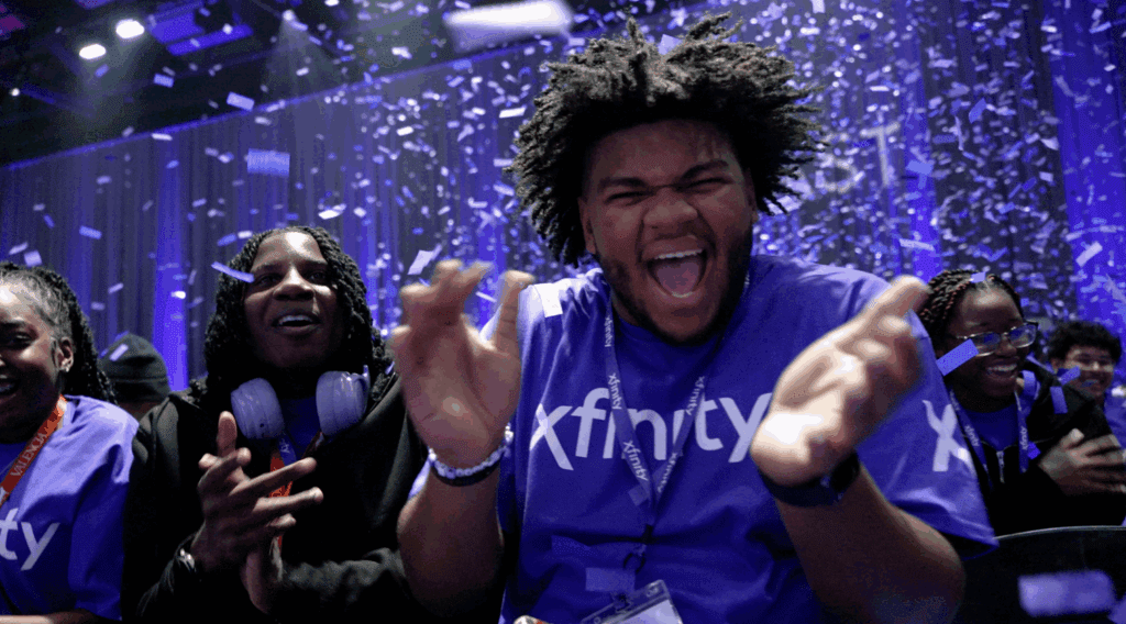 Students clapping and celebrating as confetti falls down 
